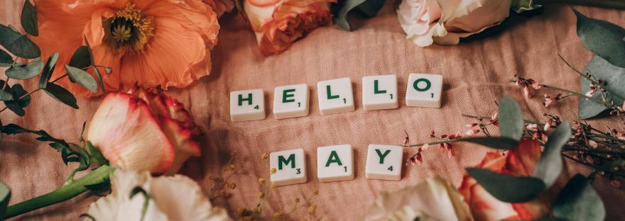 close up shot of scrabble tiles beside flowers